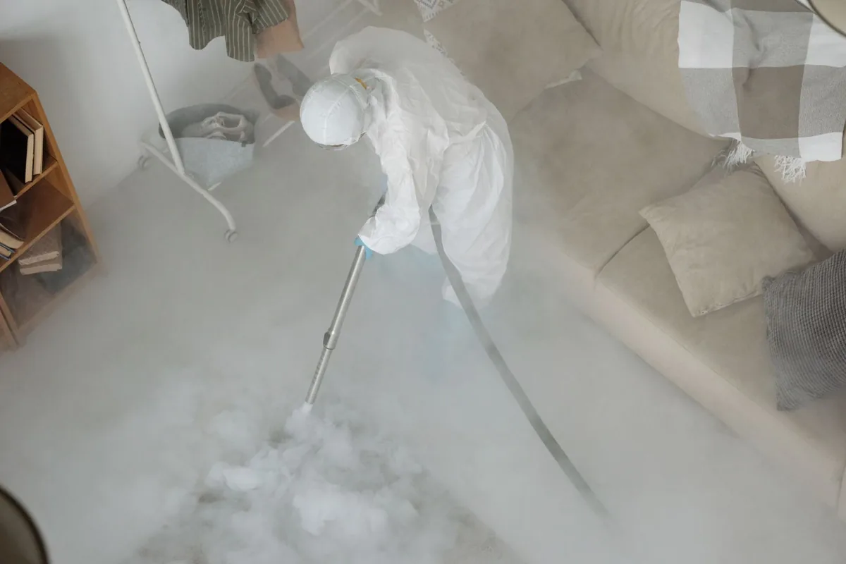 Biohazard cleanup technician in protective equipment, Lyons, KS